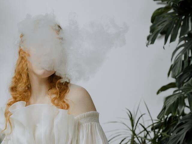 person exhale vape smoke
